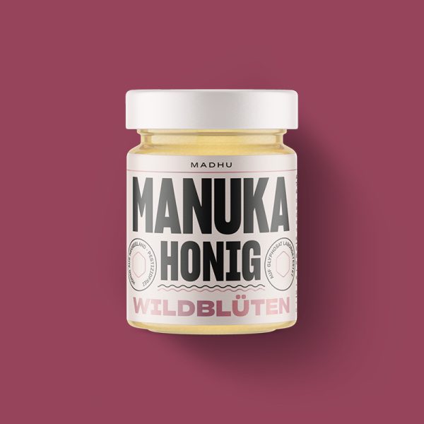 Abgebildet ist ein Manuka-Wildblüten Honig in einem 250Gramm Glas.
